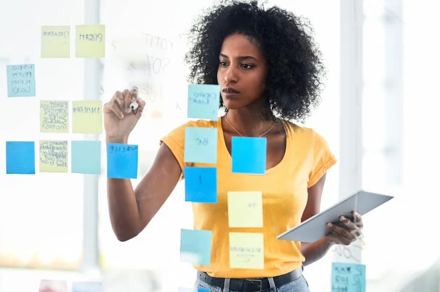 Founder planning funding options with sticky notes