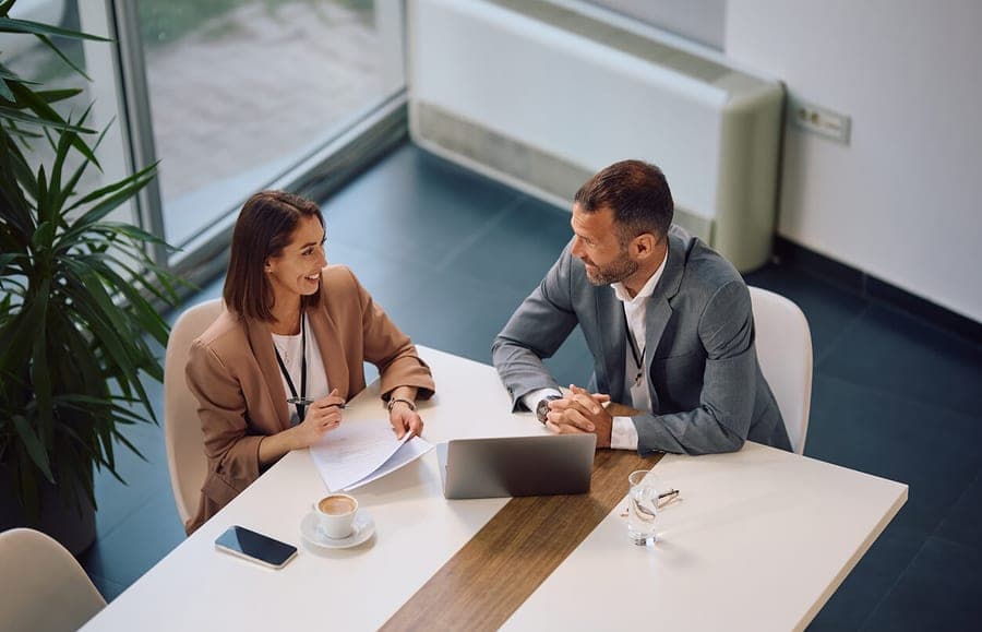 Two founders reviewing paperwork at a meeting table