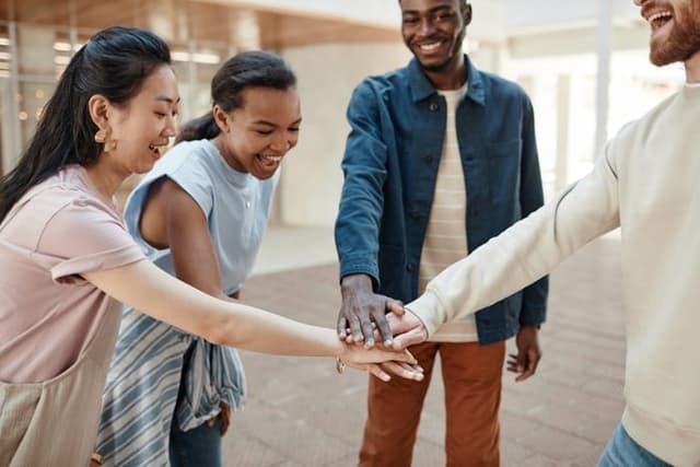 Team stacking hands together